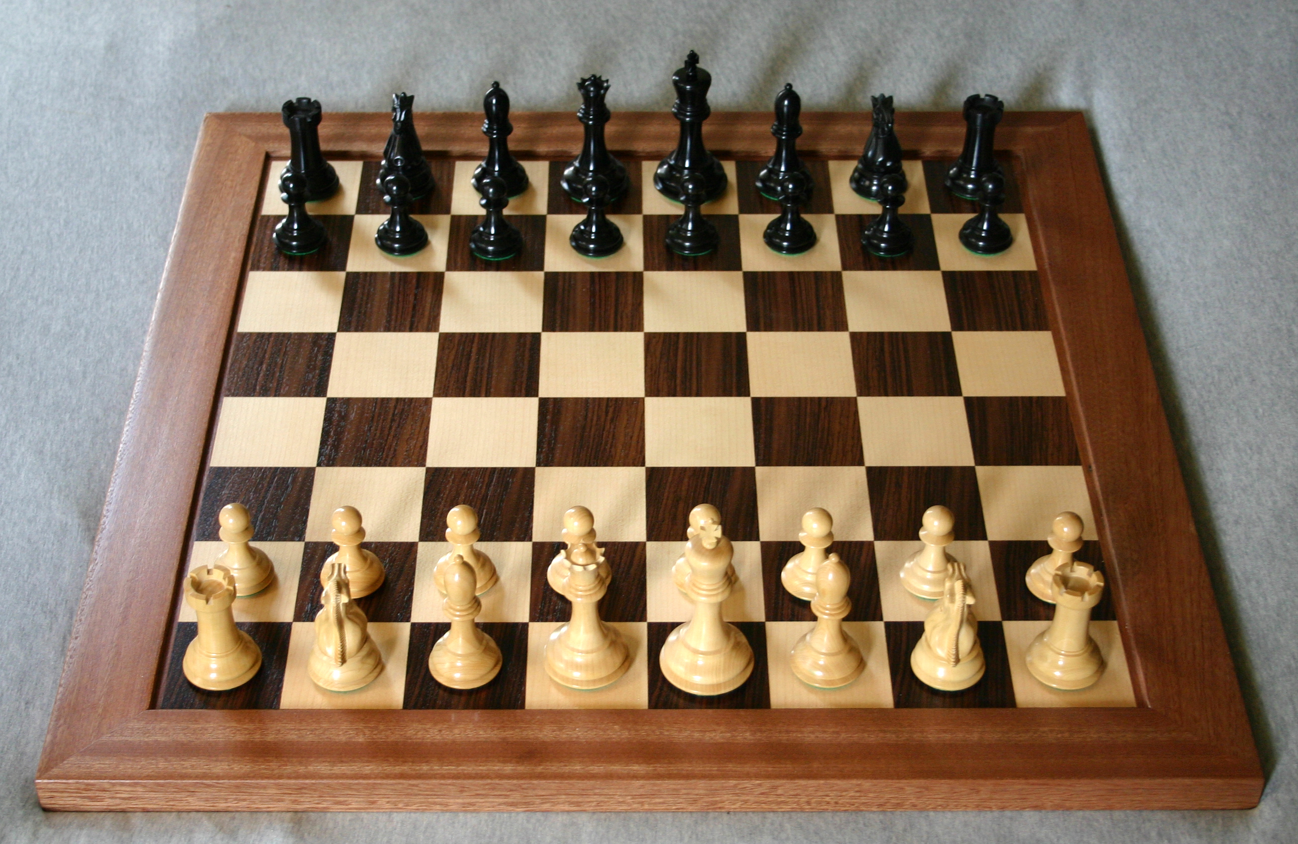 A chess board set up for a World Chess Championship match in a formal playing venue